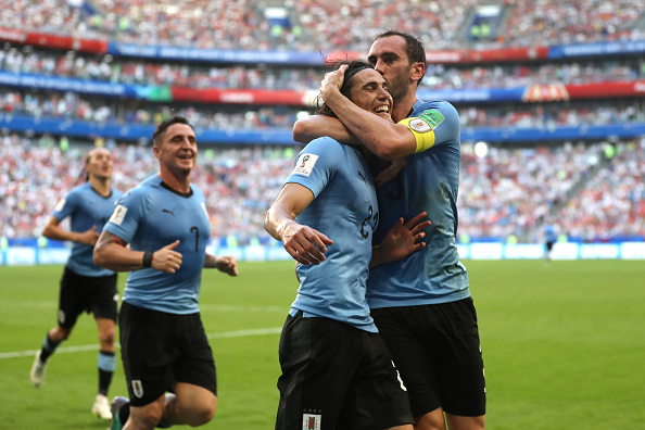 SAMARA, RUSSIA - JUNE 25:  Edinson Cavani of Uruguay celebrates with teammate Diego Godin after scoring his team's third goal  during the 2018 FIFA World Cup Russia group A match between Uruguay and Russia at Samara Arena on June 25, 2018 in Samara, Russia.  (Photo by Michael Steele/Getty Images)
