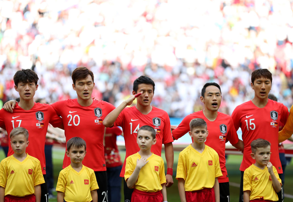 KAZAN, RUSSIA - JUNE 27:  Army corporal Hong Chul of South Korea salutes as he stands with his team mates during the national anthem before the 2018 FIFA World Cup Russia group F match between Korea Republic and Germany at Kazan Arena on June 27, 2018 in Kazan, Russia. (Photo by Catherine Ivill/Getty Images)