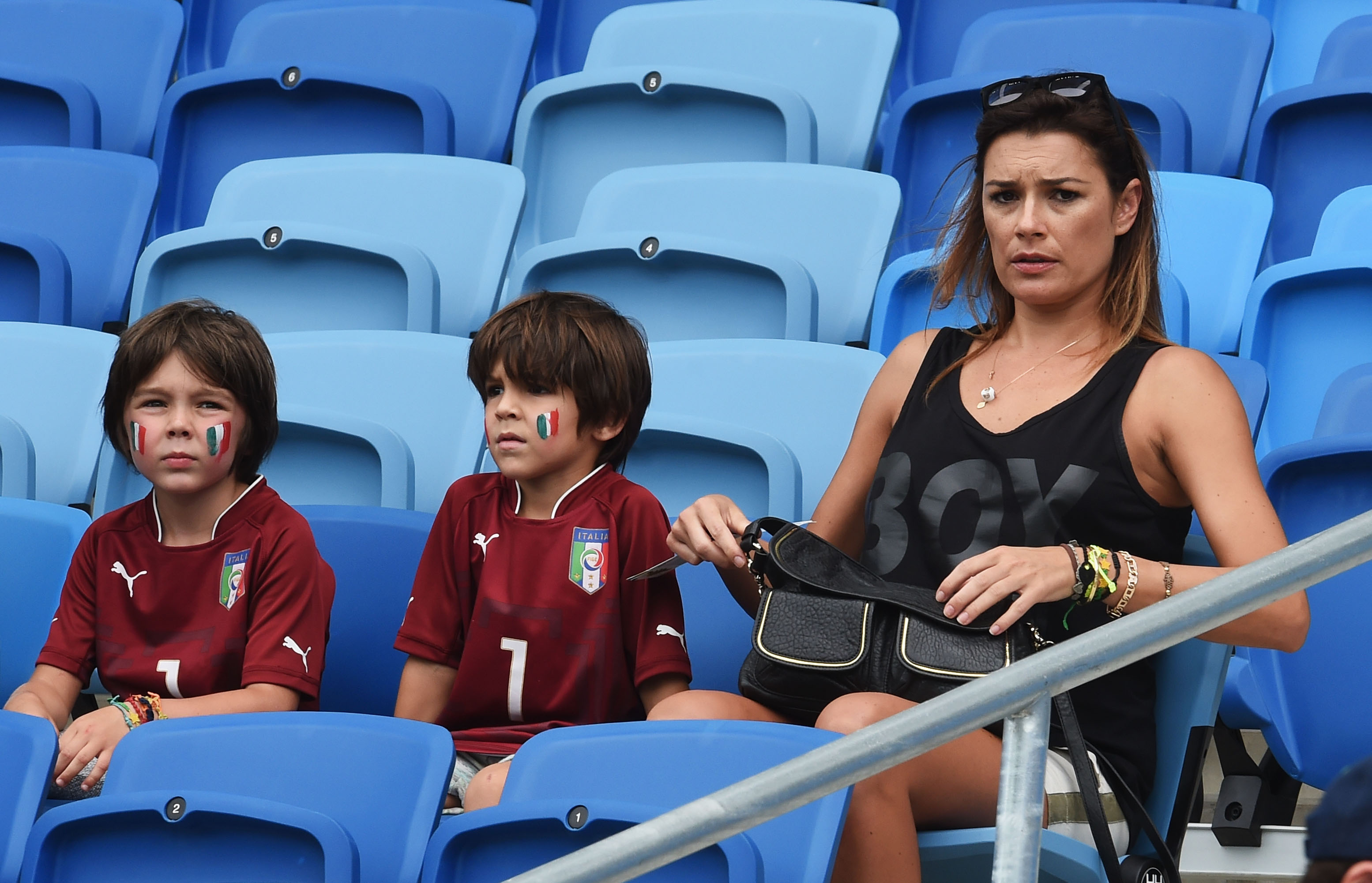 NATAL, BRAZIL - JUNE 24:  Alena Seredova, wife of Gianluigi Buffon of Italy, looks on looks on with their sons David and Louis ahead of the 2014 FIFA World Cup Brazil Group D match between Italy and Uruguay at Estadio das Dunas on June 24, 2014 in Natal, Brazil.  (Photo by Claudio Villa/Getty Images)