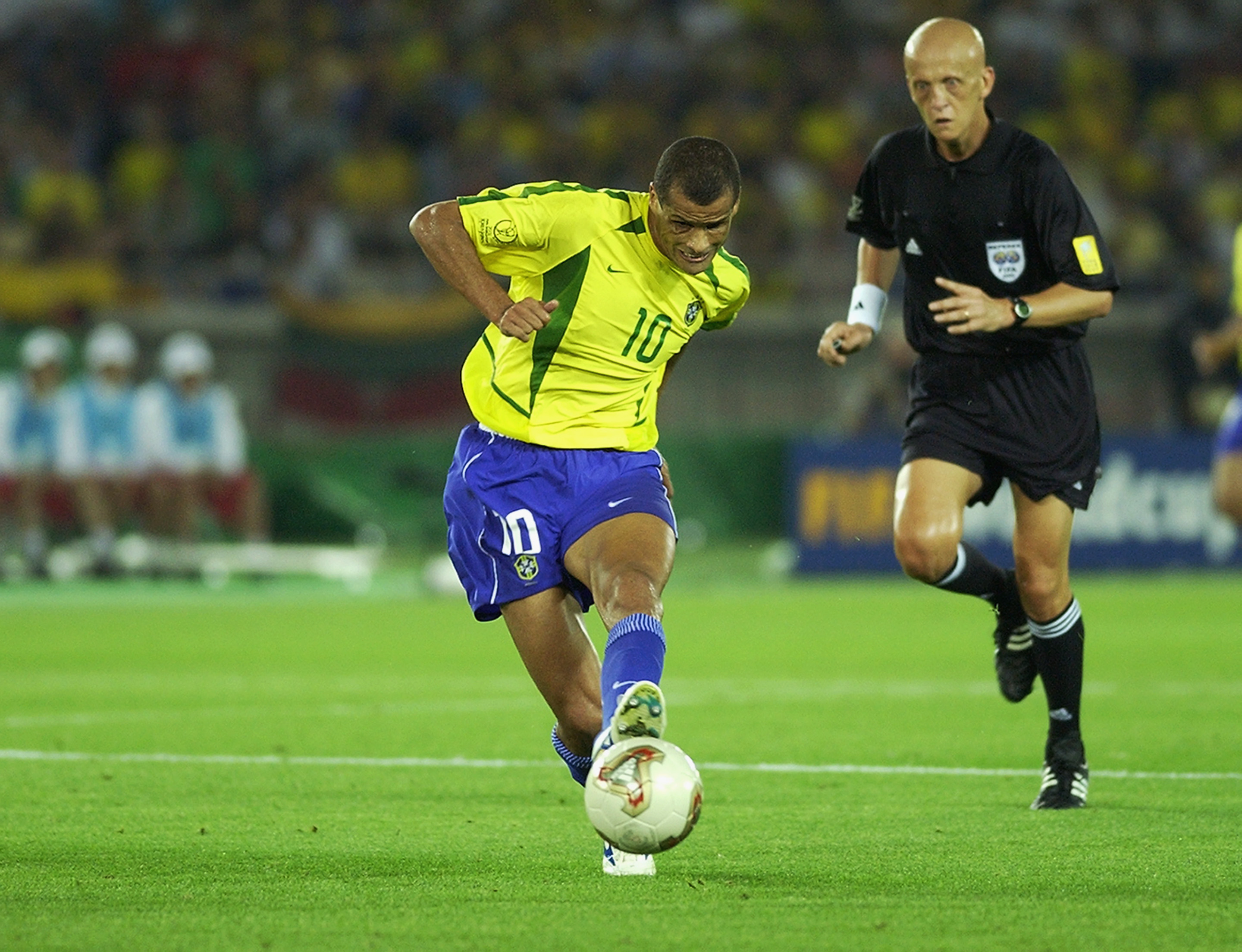 YOKOHAMA - JUNE 30:  Rivaldo of Brazil is watched by referee Pierluigi Collina during the Germany v Brazil, World Cup Final match played at the International Stadium Yokohama, Yokohama, Japan on June 30, 2002. Brazil won 2-0. (Photo by Gary M. Prior/Getty Images)