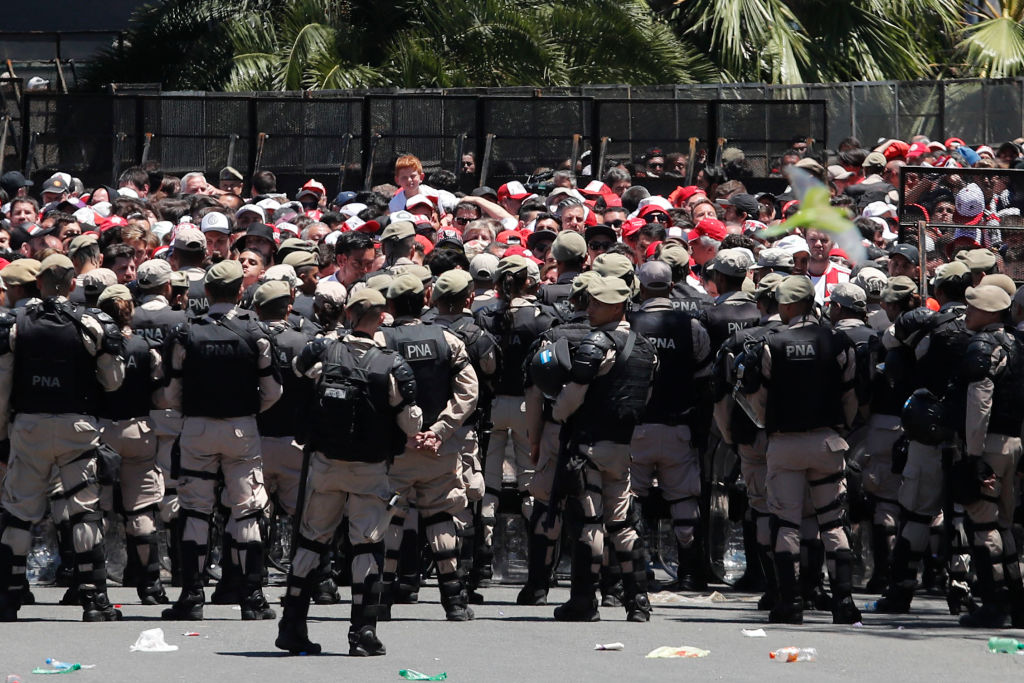 BUENOS AIRES, ARGENTINA - NOVEMBER 25: Riot police stand guard outside of Monumental Stadium of River Plate before the second leg of the  final of Copa CONMEBOL Libertadores 2018 between River Plate and Boca Juniors at Estadio Monumental Antonio Vespucio Liberti on November 25, 2018 in Buenos Aires, Argentina. The match was postponed again today due to the attacks suffered by players of Boca Juniors on their arrival to the stadium yesterday. (Photo by Marcelo Hernandez/Getty Images)