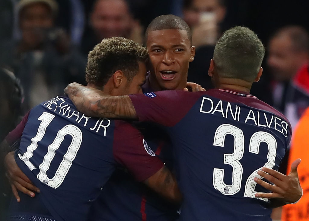 PARIS, FRANCE - SEPTEMBER 27: Neymar of PSG (L) celebrates with Kylian Mbappe of PSG and Dani Alves of PSG after scoring his sides third goal during the UEFA Champions League group B match between Paris Saint-Germain and Bayern Muenchen at Parc des Princes on September 27, 2017 in Paris, France.  (Photo by Alexander Hassenstein/Bongarts/Getty Images)