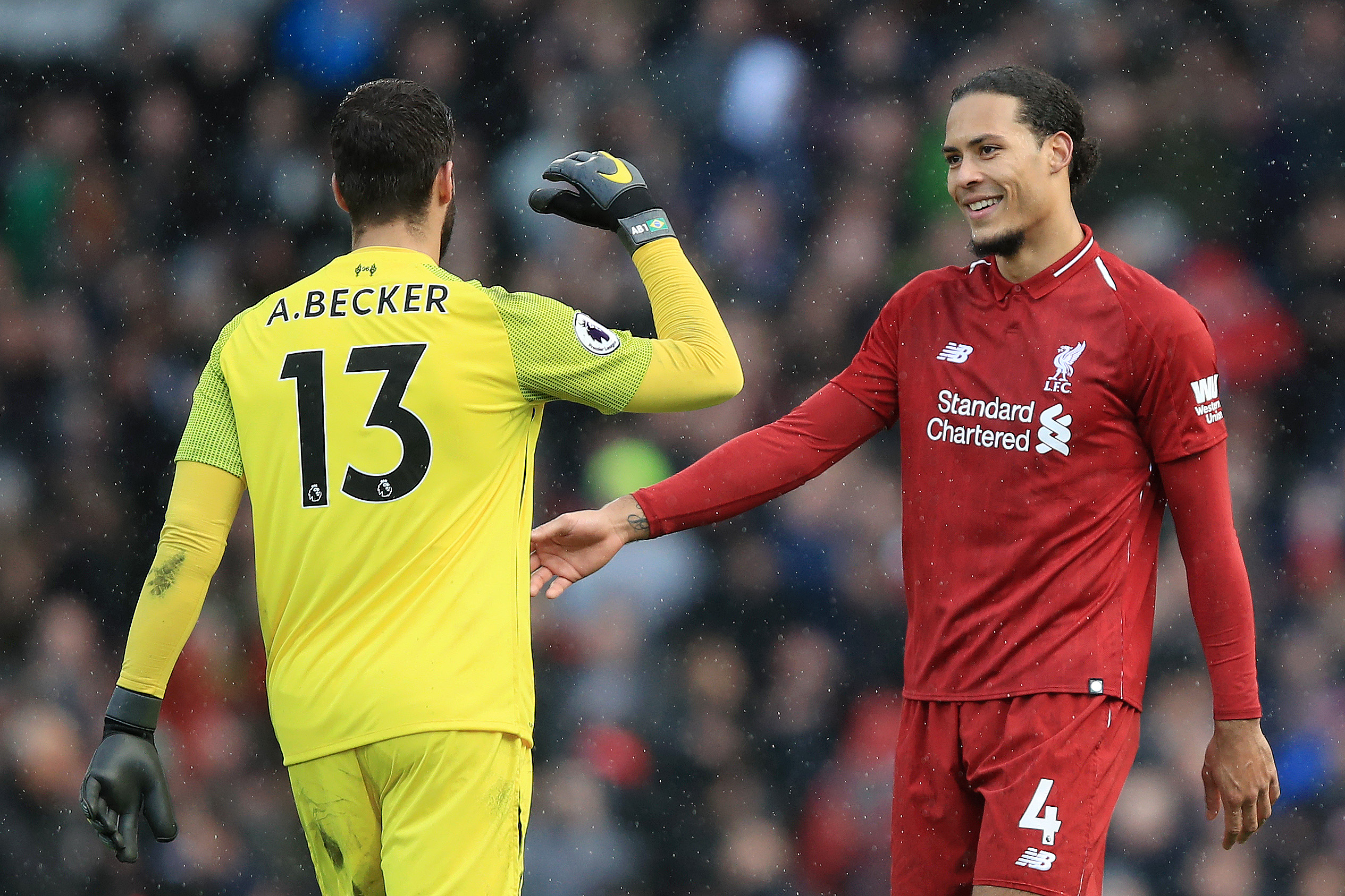 LONDON, ENGLAND - MARCH 17:   Alisson of Liverpool shakes hands with Virgil van Dijk of Liverpool after the Premier League match between Fulham FC and Liverpool FC at Craven Cottage on March 17, 2019 in London, United Kingdom. (Photo by Marc Atkins/Getty Images)
