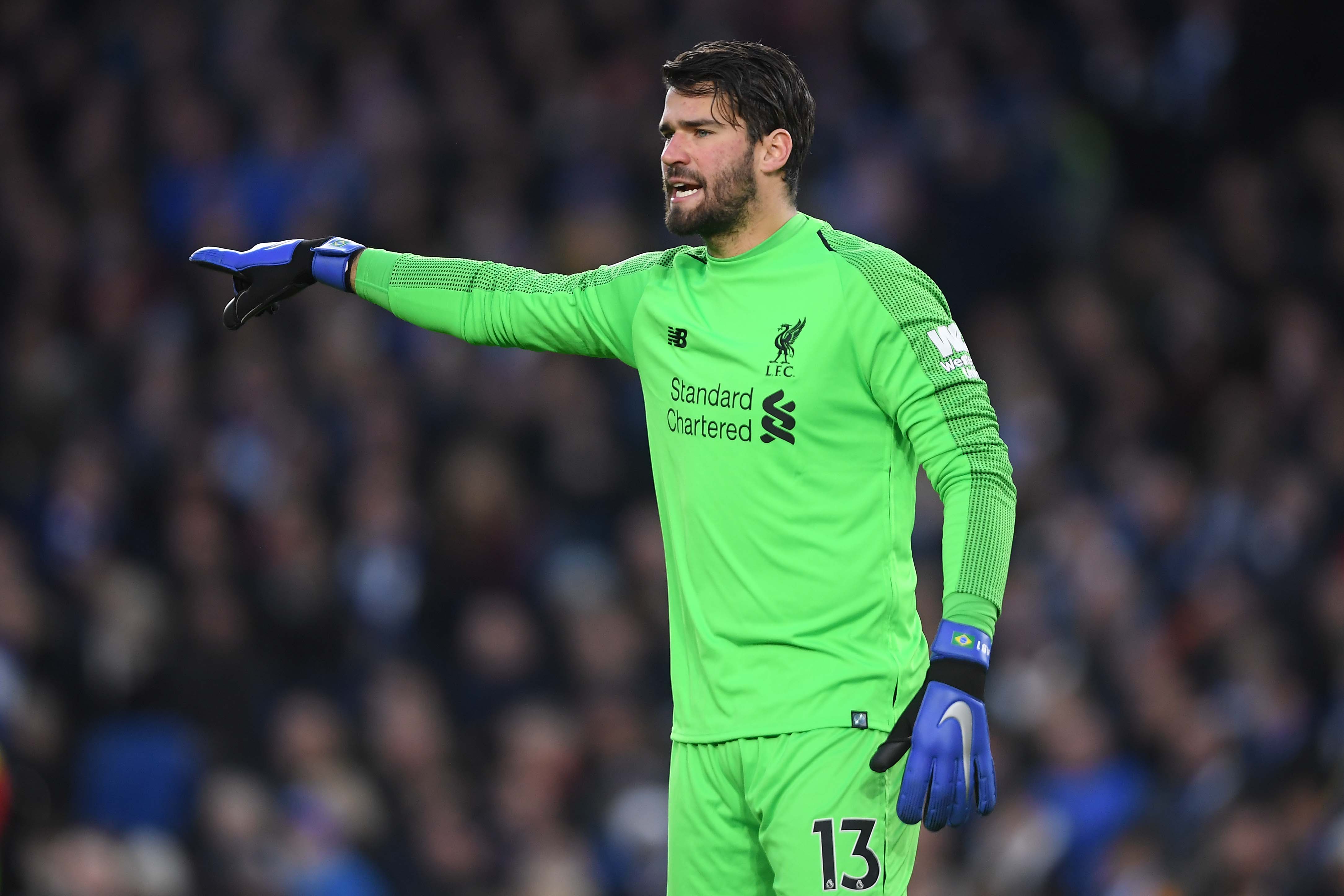 BRIGHTON, ENGLAND - JANUARY 12: Alisson Becker of Liverpool points during the Premier League match between Brighton & Hove Albion and Liverpool FC at American Express Community Stadium on January 12, 2019 in Brighton, United Kingdom. (Photo by Mike Hewitt/Getty Images)