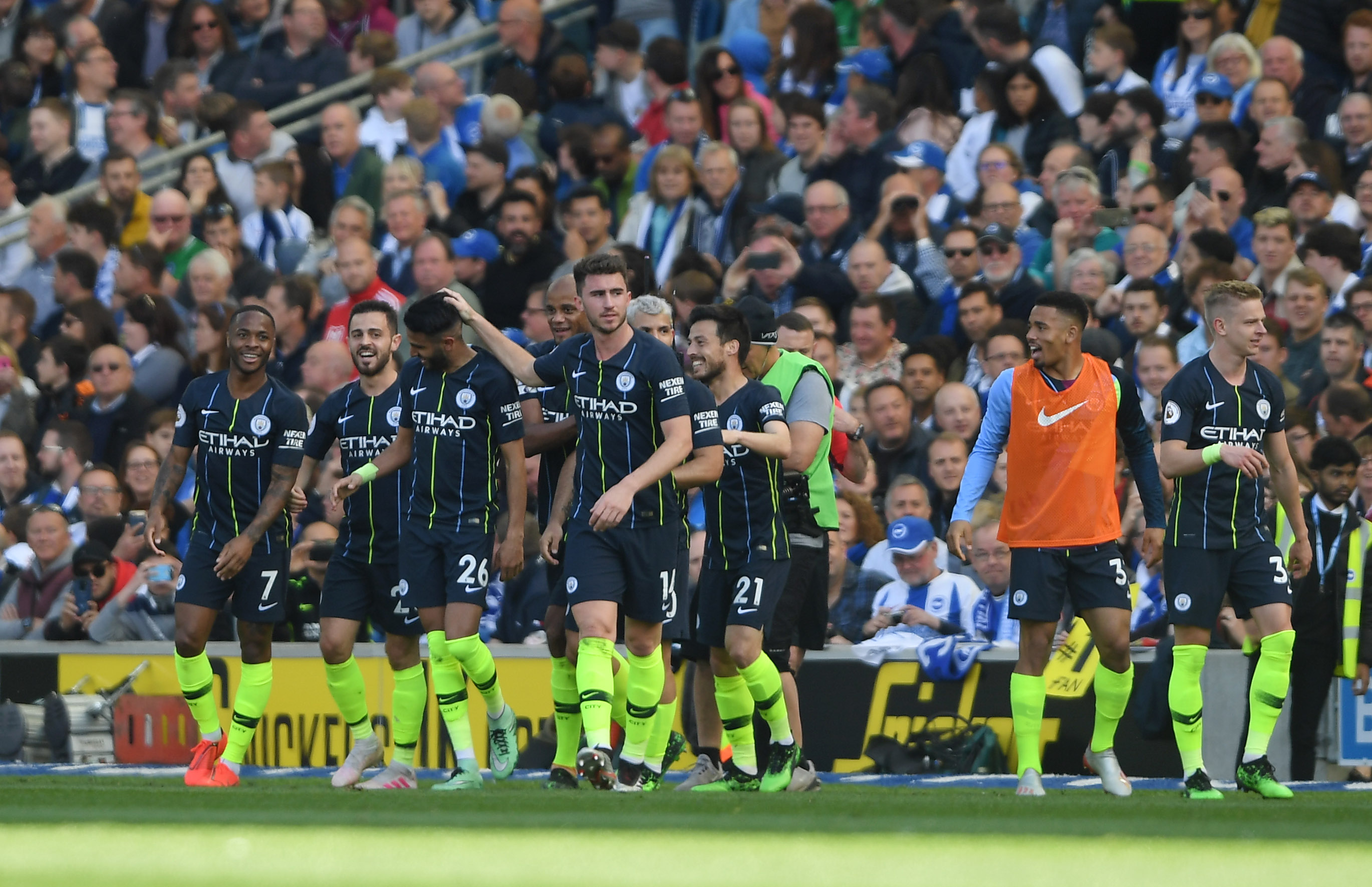 BRIGHTON, ENGLAND - MAY 12: Riyad Mahrez of Manchester City celebrates with teammates after scoring his team's third goal during the Premier League match between Brighton & Hove Albion and Manchester City at American Express Community Stadium on May 12, 2019 in Brighton, United Kingdom. (Photo by Mike Hewitt/Getty Images)