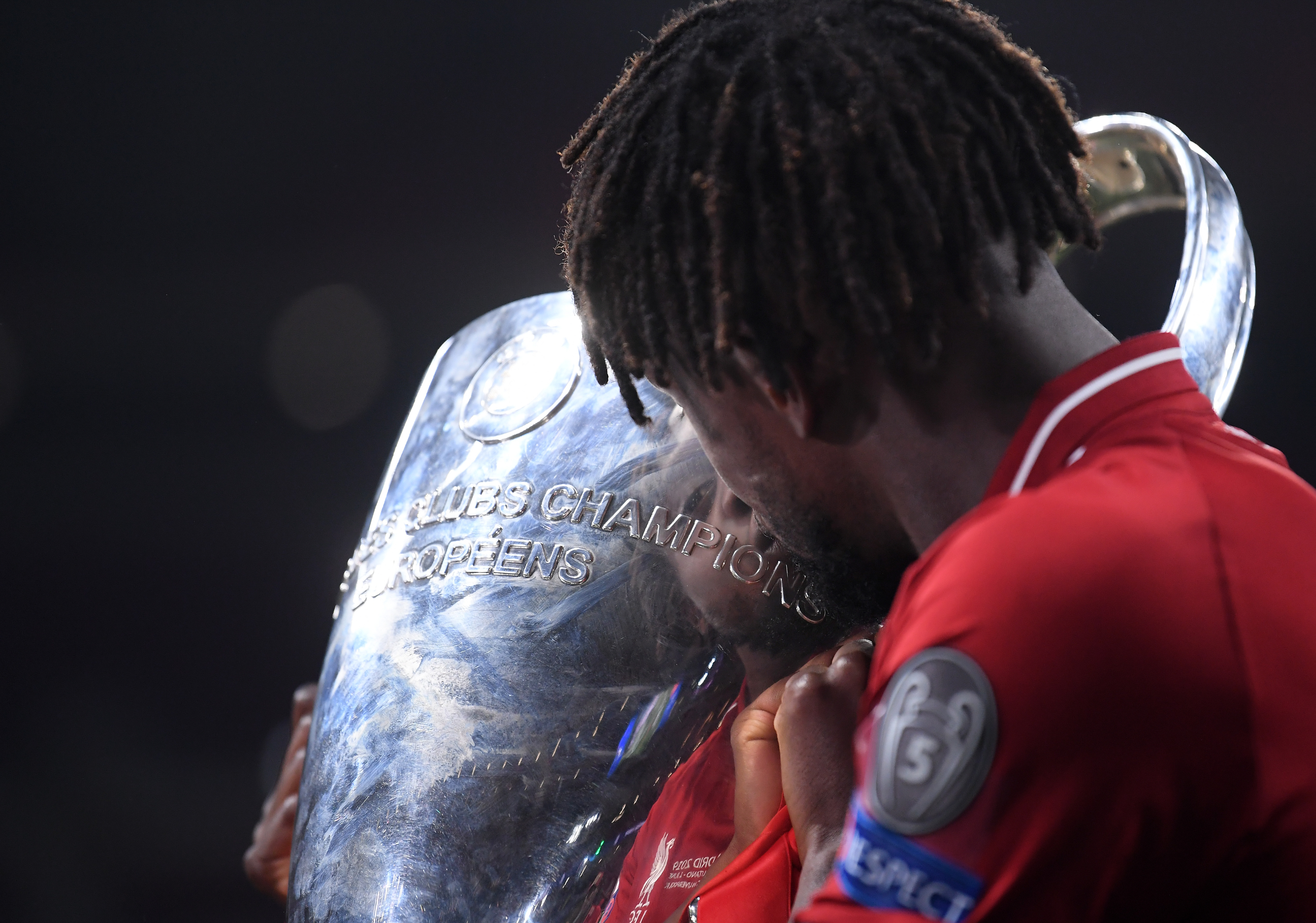 MADRID, SPAIN - JUNE 01: Divock Origi of Liverpool celebrates with the Champions League Trophy after winning the UEFA Champions League Final between Tottenham Hotspur and Liverpool at Estadio Wanda Metropolitano on June 01, 2019 in Madrid, Spain. (Photo by Laurence Griffiths/Getty Images)