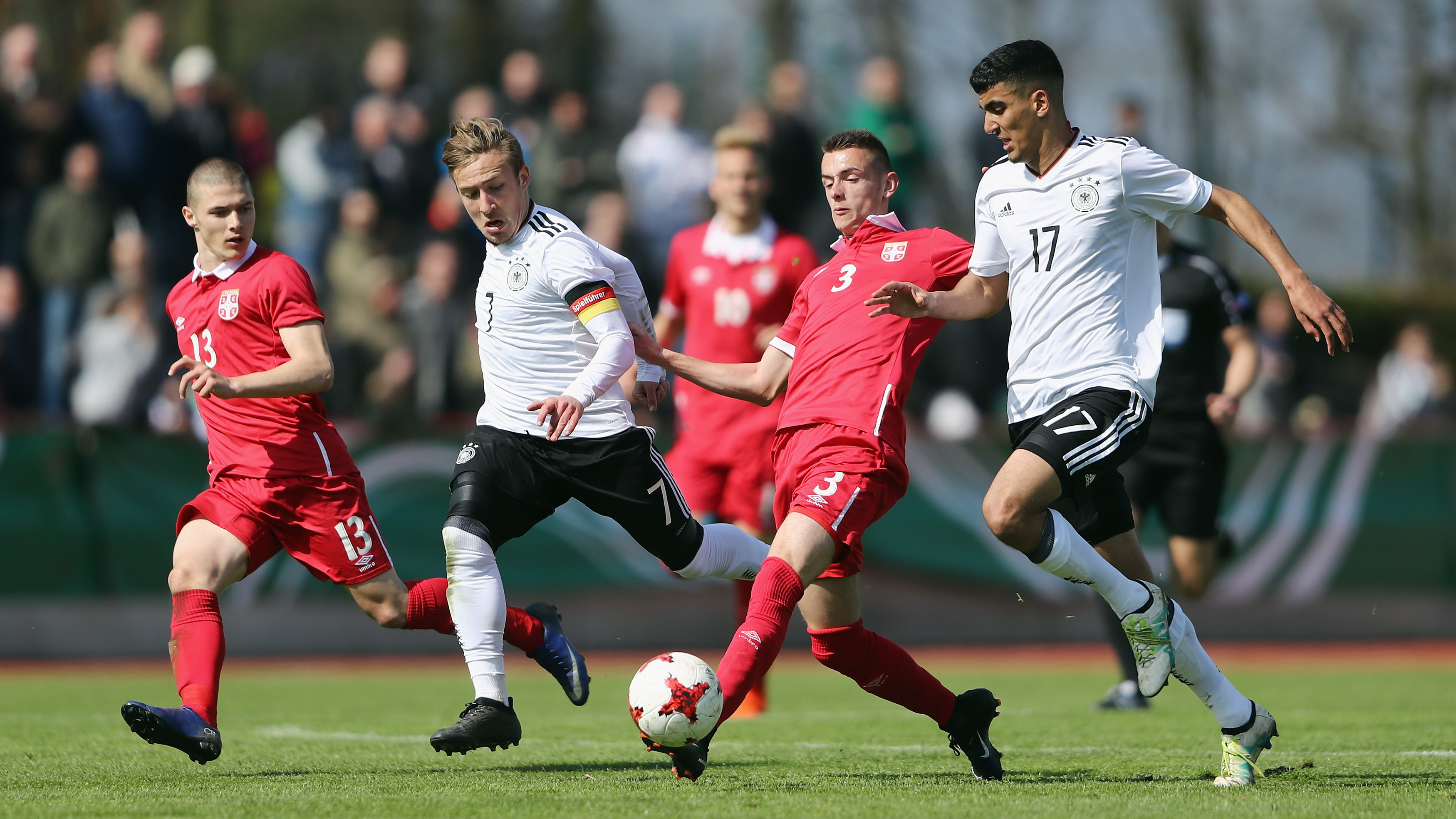 KELSTERBACH, GERMANY - MARCH 25: Aleksa Terzic (C) of Serbia is challenged by Tobias Warschewski (R) and Felix Passlack of Germany during the UEFA Elite Round match between U19 Germany and U19 Serbia at Sportpark on March 25, 2017 in Kelsterbach, Germany.  (Photo by Alex Grimm/Bongarts/Getty Images)
